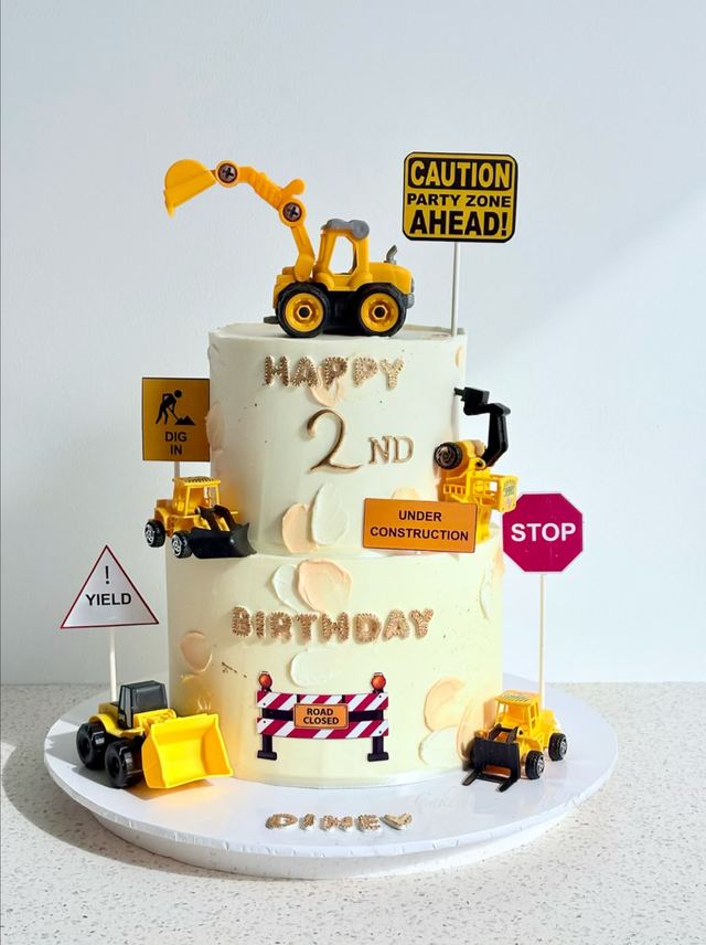Two-tier construction-themed 2nd birthday cake with toy diggers, road signs and gold lettering by Cake by O2, Colombo