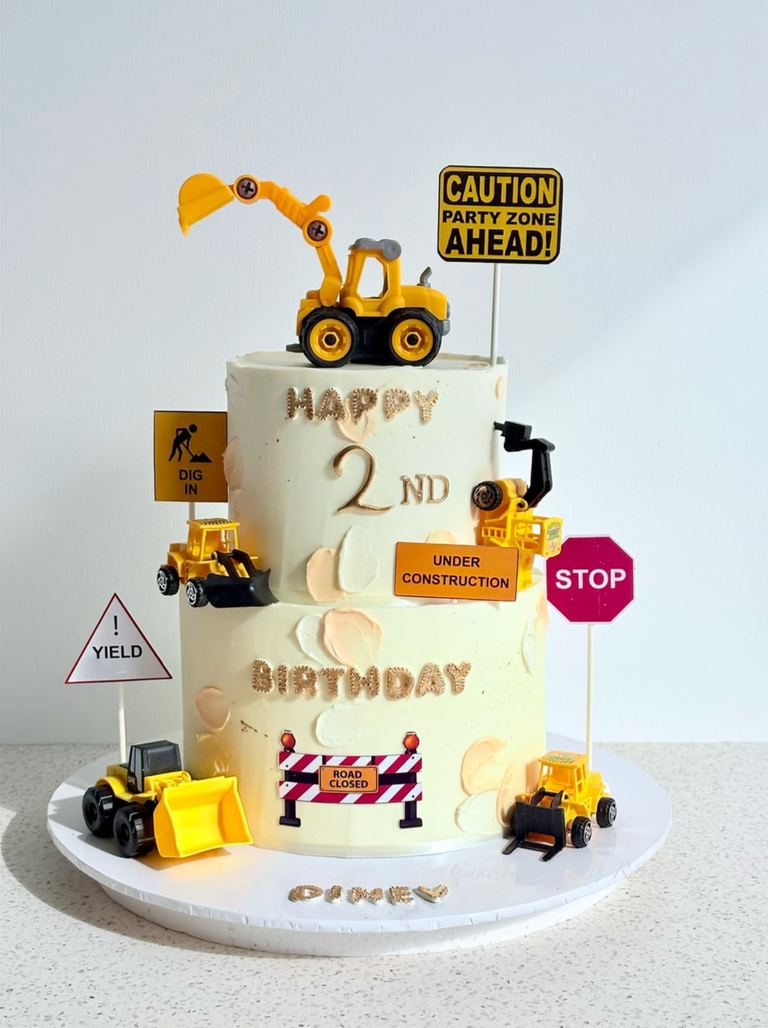 Two-tier construction-themed 2nd birthday cake with toy diggers, road signs and gold lettering by Cake by O2, Colombo